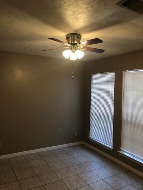 3603 Nevada Dr, San Angelo, TX 76904 - unfurnished room featuring a ceiling fan, tile patterned flooring, and a textured ceiling
