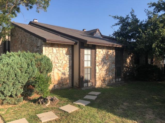3603 Nevada Dr, San Angelo, TX 76904 - view of side of home featuring stone siding and a yard