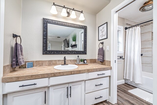 3513 Lindenwood Dr, San Angelo, TX 76904 - full bath featuring vanity, wood finished floors, and shower / tub combo