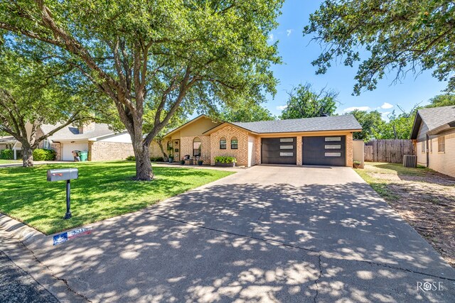 3513 Lindenwood Dr, San Angelo, TX 76904 - view of front of property with driveway, an attached garage, and brick siding