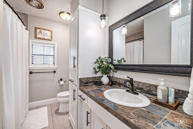 3513 Lindenwood Dr, San Angelo, TX 76904 - bathroom featuring vanity, a shower with shower curtain, and a textured ceiling