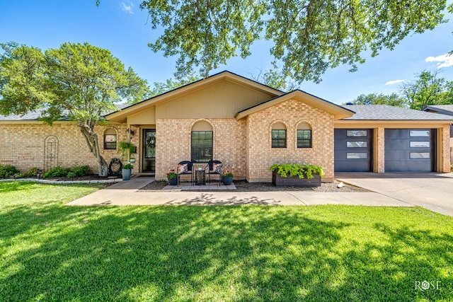 3513 Lindenwood Dr, San Angelo, TX 76904 - view of front of house with a garage, concrete driveway, a front lawn, and brick siding