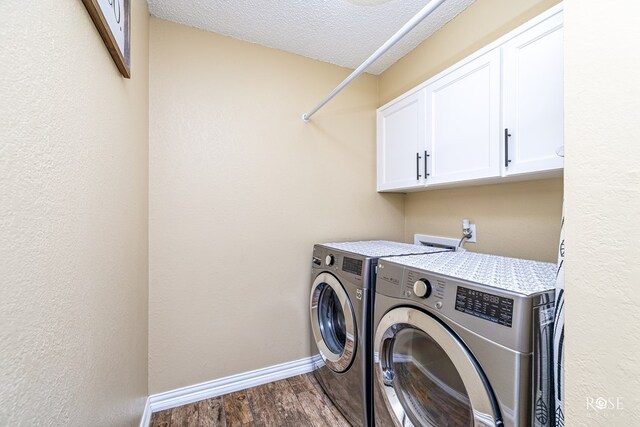 3513 Lindenwood Dr, San Angelo, TX 76904 - washroom featuring separate washer and dryer, cabinet space, dark wood-style flooring, and a textured ceiling