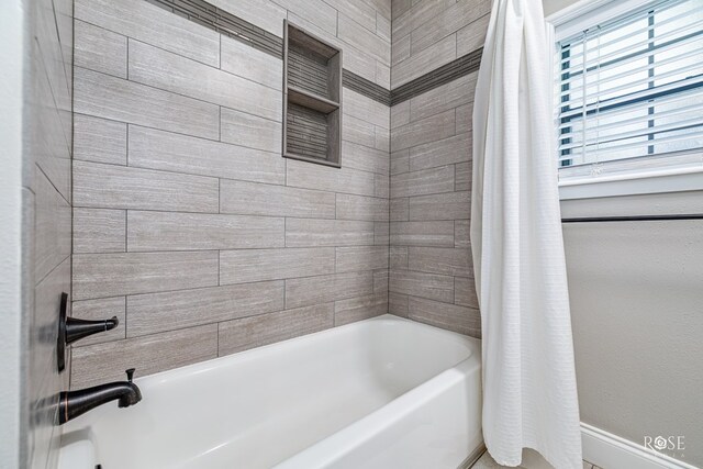 3513 Lindenwood Dr, San Angelo, TX 76904 - bathroom featuring shower / tub combo with curtain and baseboards