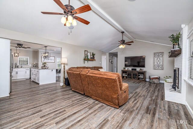 3513 Lindenwood Dr, San Angelo, TX 76904 - living area with ceiling fan, dark wood-style flooring, and a brick fireplace