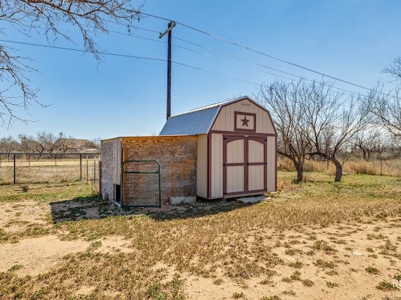 view of shed with fence