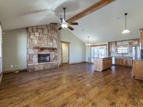 kitchen with visible vents, dark wood finished floors, appliances with stainless steel finishes, open floor plan, and a stone fireplace