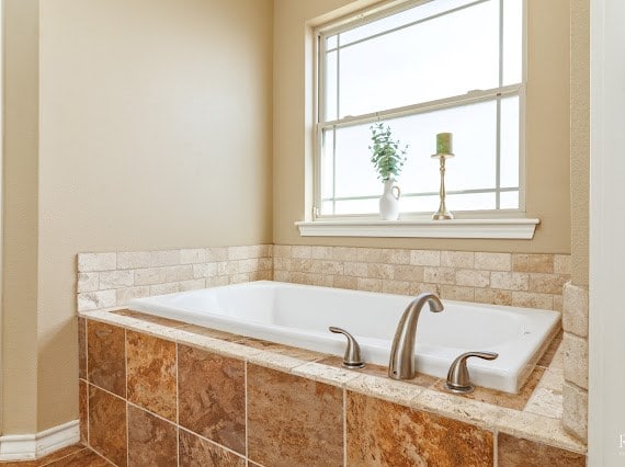 full bath with a garden tub