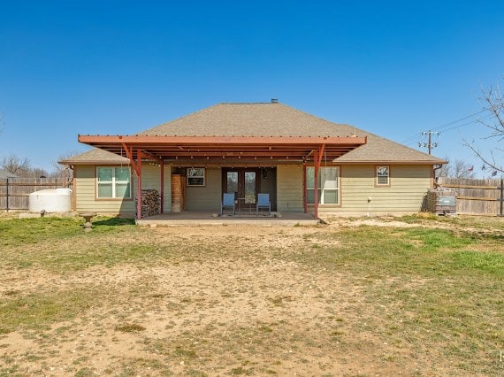 back of property featuring a patio area, fence, and a lawn