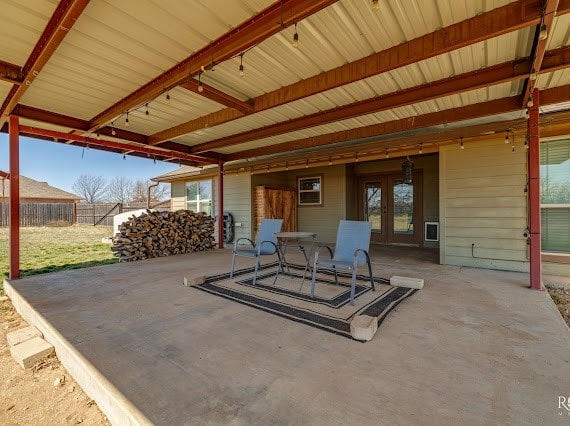 view of patio / terrace featuring fence and french doors