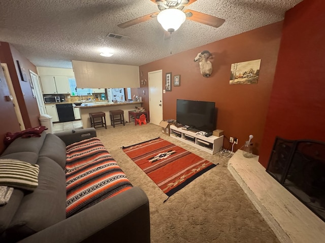 living room featuring ceiling fan, a textured ceiling, and carpet flooring