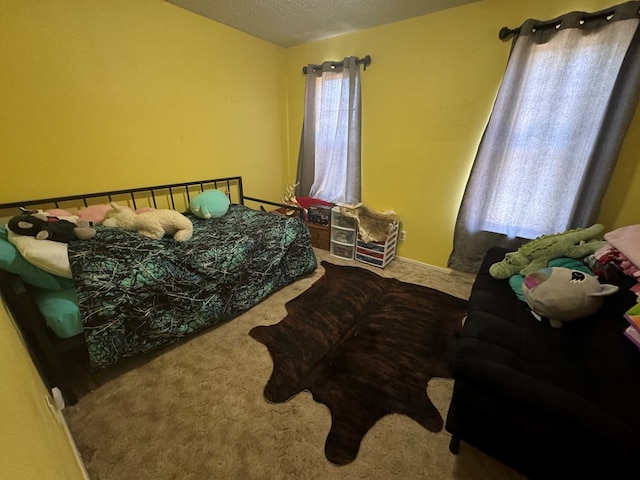 carpeted bedroom with a textured ceiling