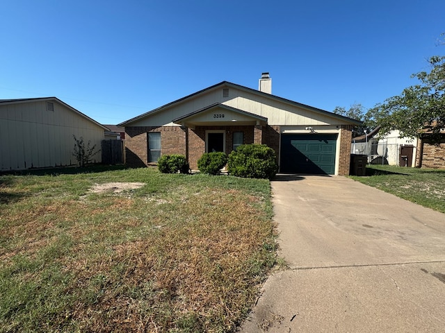 ranch-style home featuring a garage and a front lawn