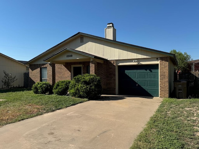 ranch-style house featuring a garage and a front yard