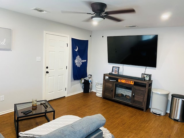 living room featuring dark hardwood / wood-style flooring and ceiling fan