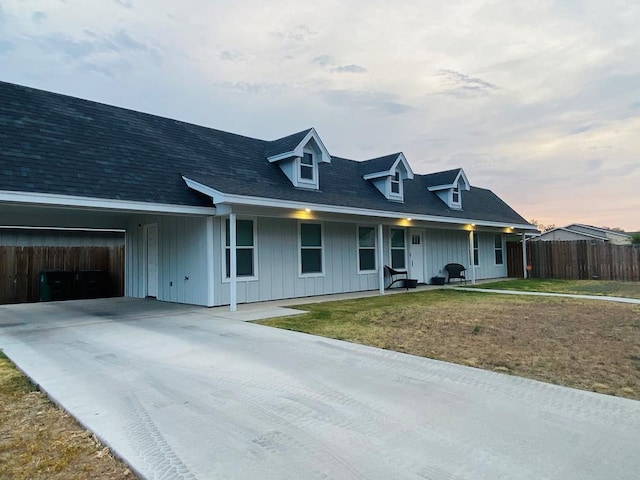 view of front facade with a carport and a yard