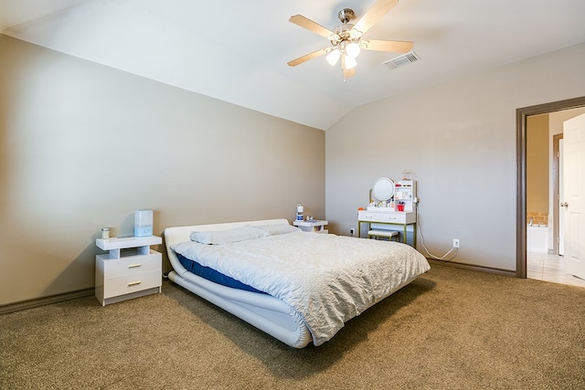 carpeted bedroom with baseboards, visible vents, vaulted ceiling, and a ceiling fan