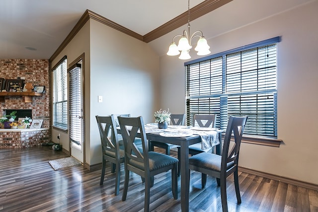 dining area featuring ornamental molding, a notable chandelier, and wood finished floors