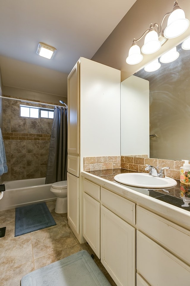 full bathroom featuring shower / bath combo, tile patterned flooring, vanity, and toilet