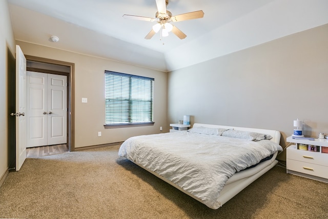 bedroom with vaulted ceiling, ceiling fan, carpet, and baseboards