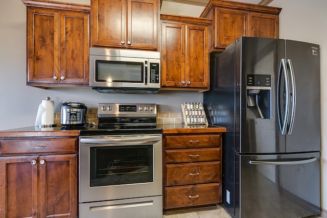 kitchen featuring appliances with stainless steel finishes and dark countertops