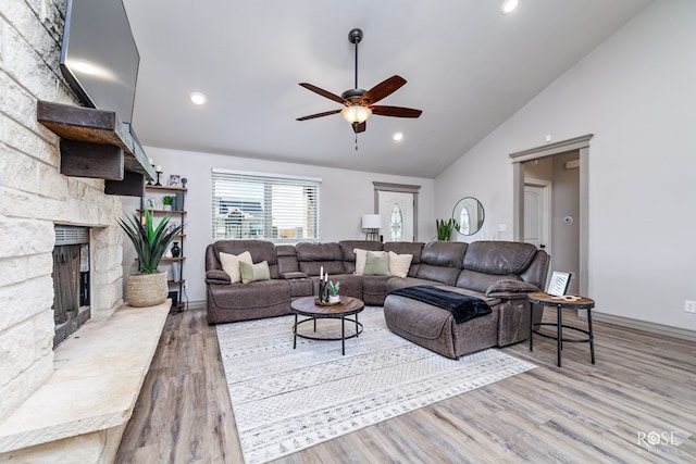 living area featuring recessed lighting, a fireplace, a ceiling fan, and wood finished floors