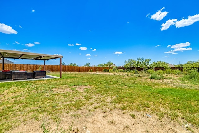 view of yard featuring a patio area, an outdoor living space, and a fenced backyard