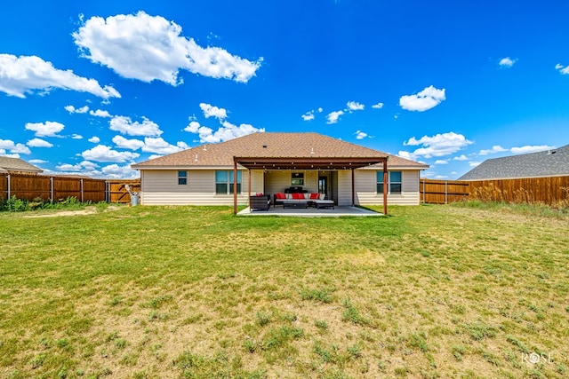 rear view of property with a yard, a patio area, and a fenced backyard