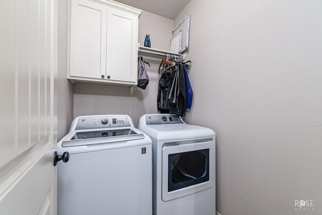 laundry room featuring washer and dryer and cabinet space