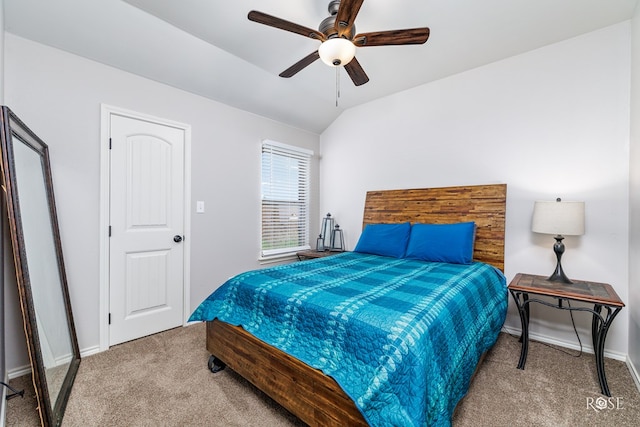 carpeted bedroom featuring baseboards, lofted ceiling, and a ceiling fan