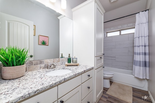 bathroom with vanity, shower / bathtub combination with curtain, toilet, and wood finished floors