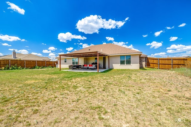 back of property with a patio, a lawn, and a fenced backyard