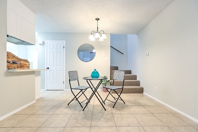 dining area featuring baseboards, a chandelier, a textured ceiling, stairway, and light tile patterned flooring