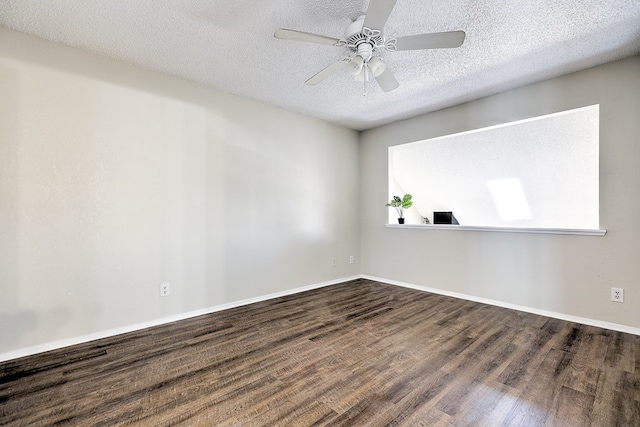 empty room featuring ceiling fan, dark wood-style floors, baseboards, and a textured ceiling