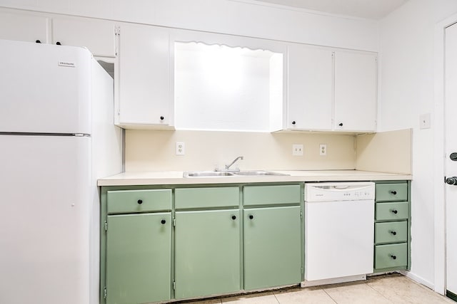 kitchen featuring white appliances, green cabinets, light countertops, and a sink