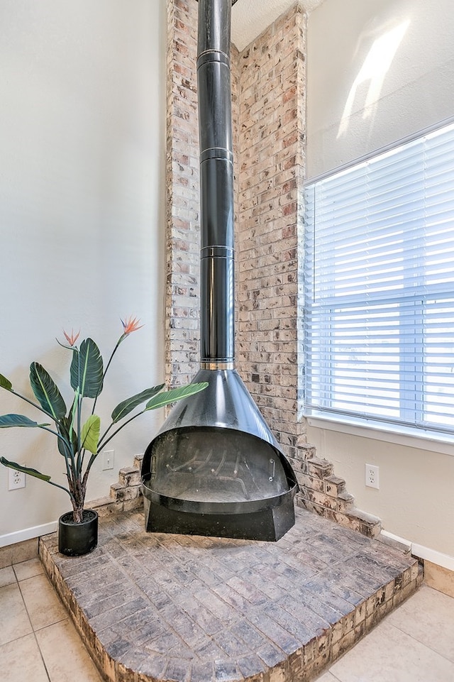 room details featuring a wood stove and baseboards