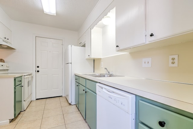 kitchen featuring a sink, light countertops, white appliances, under cabinet range hood, and light tile patterned flooring