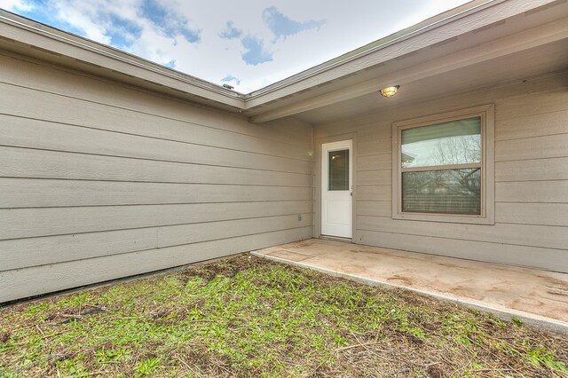 doorway to property with a patio