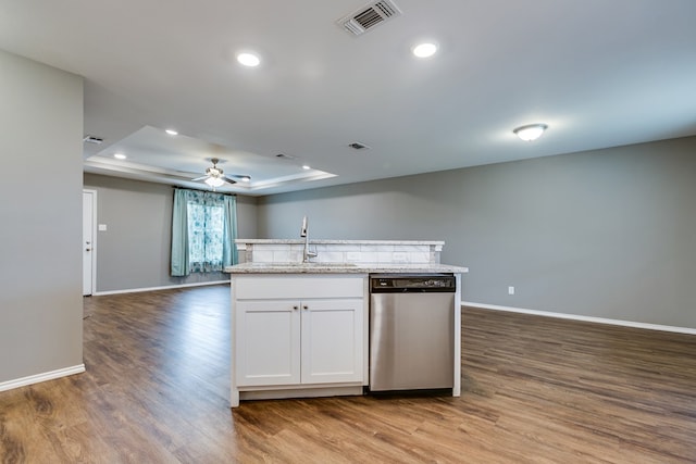 kitchen with light hardwood / wood-style flooring, sink, white cabinetry, dishwasher, and a raised ceiling