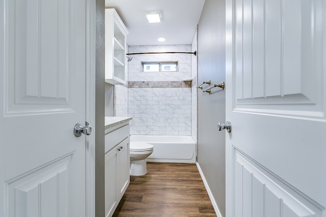 full bathroom featuring tiled shower / bath combo, vanity, toilet, and hardwood / wood-style floors