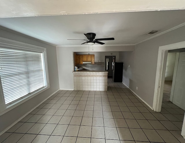 unfurnished living room featuring ornamental molding, tile patterned flooring, visible vents, and a ceiling fan