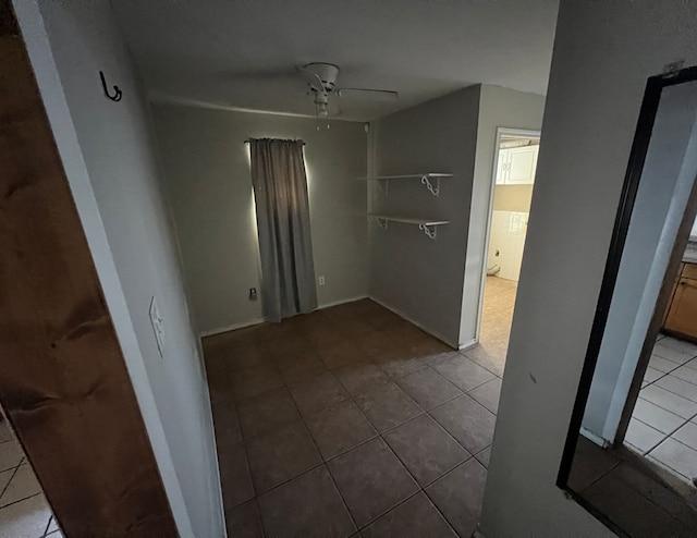 unfurnished dining area featuring light tile patterned floors and ceiling fan