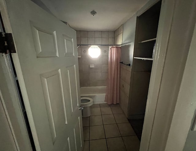 bathroom with toilet, shower / bath combo with shower curtain, and tile patterned floors