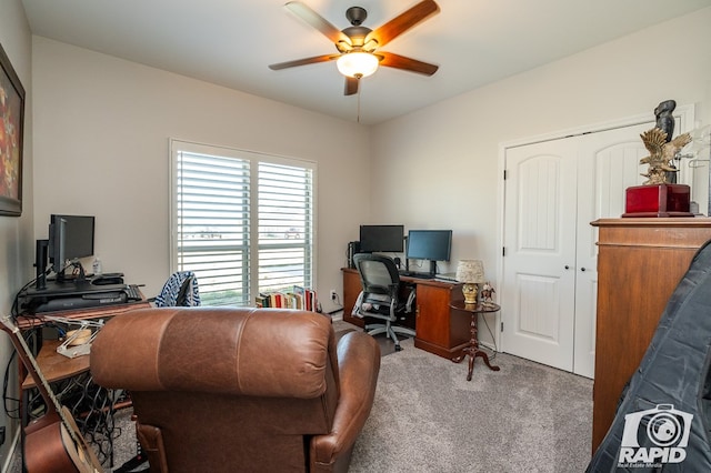 home office with ceiling fan and carpet flooring