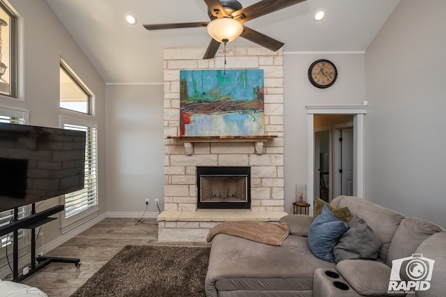 living room with lofted ceiling, plenty of natural light, a fireplace, and light hardwood / wood-style floors