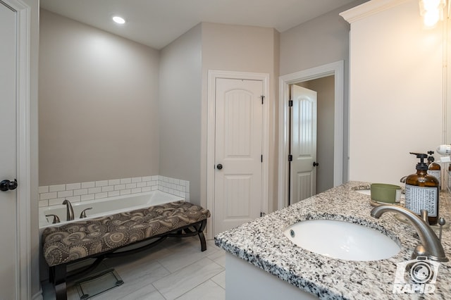 bathroom with vanity, tile patterned flooring, and a bathtub