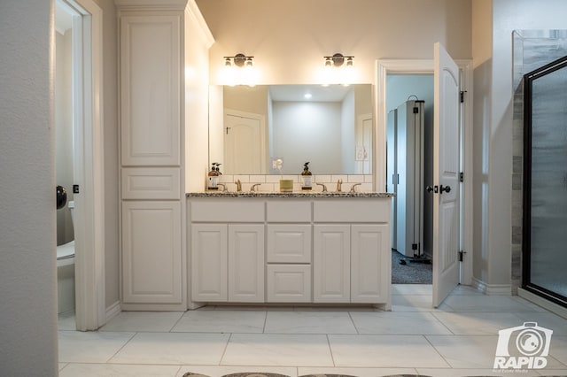 bathroom featuring walk in shower, vanity, and toilet