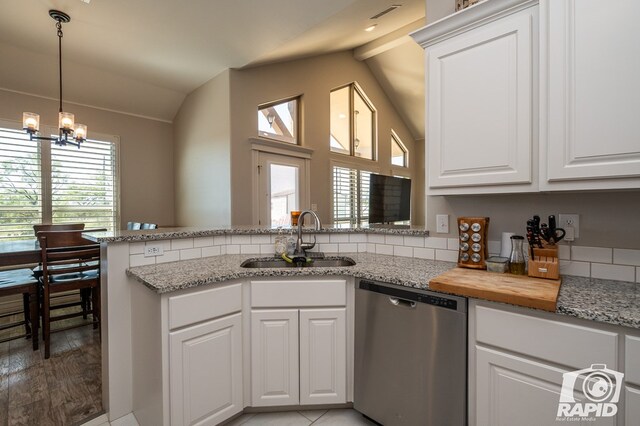 kitchen with sink, dishwasher, white cabinetry, lofted ceiling with beams, and kitchen peninsula