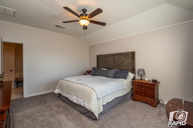 carpeted bedroom with ceiling fan and vaulted ceiling