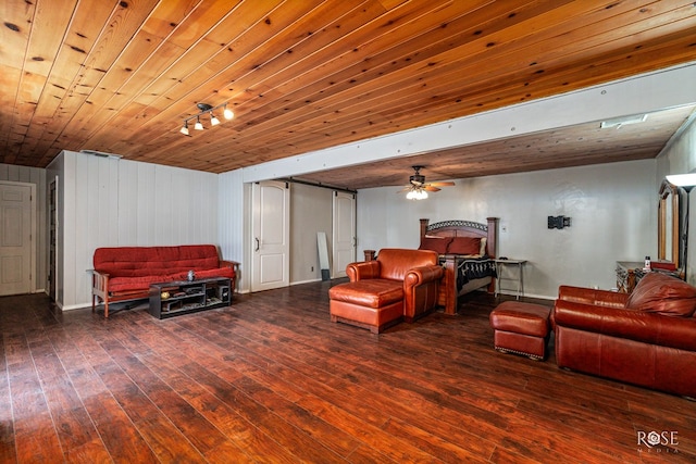 interior space featuring dark hardwood / wood-style flooring, wood ceiling, a barn door, and ceiling fan